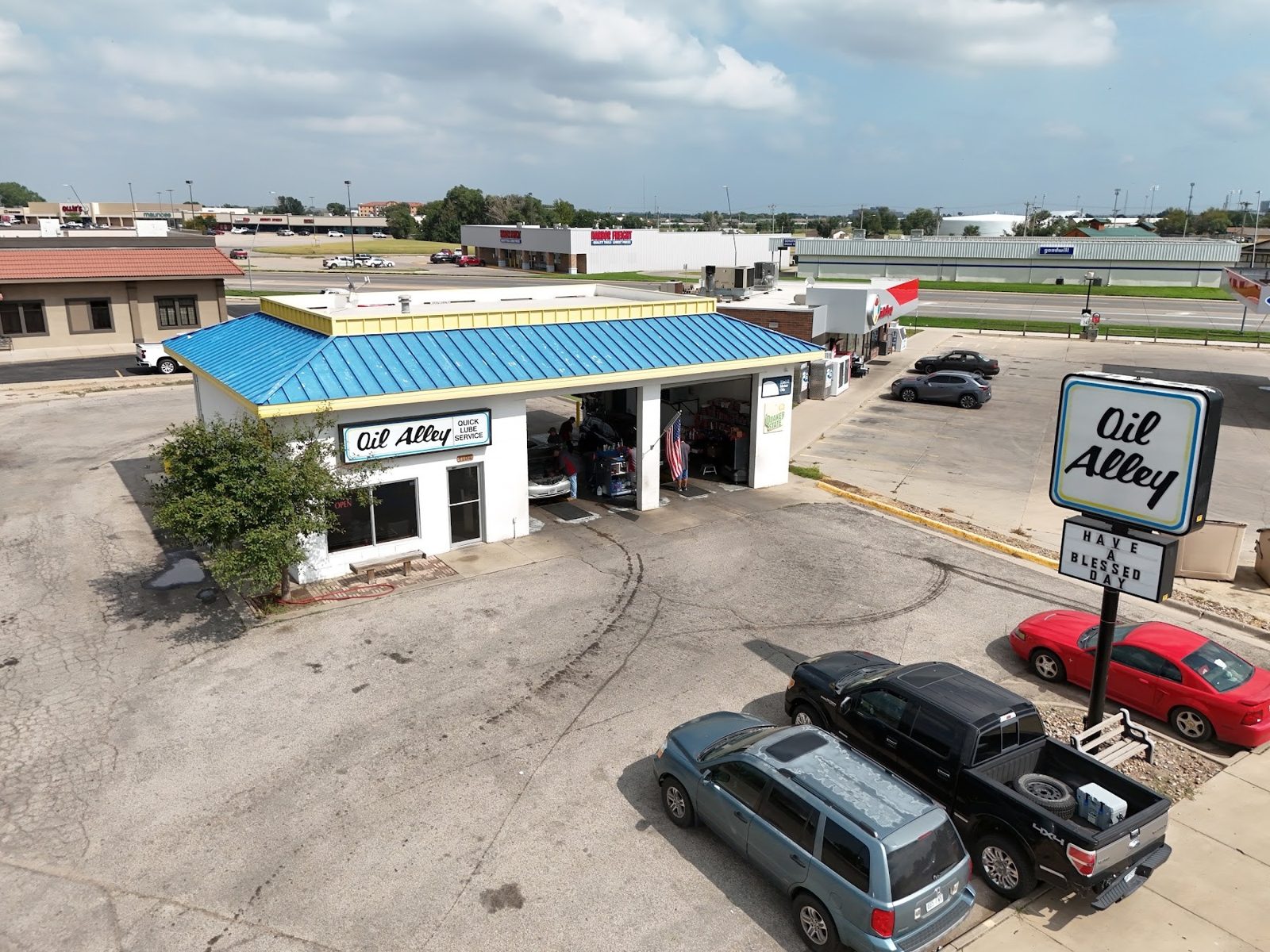 Aerial view of the Oil Alley shop on Campus Drive in Garden City, with its blue roof and service bays
